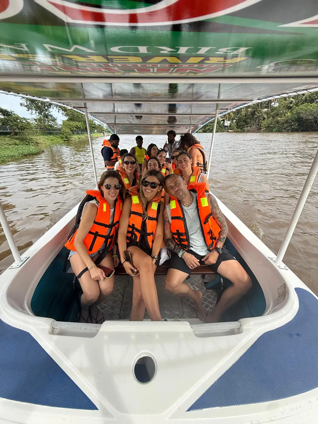 A full boat of guests in life jackets on a Nilwala River safari
